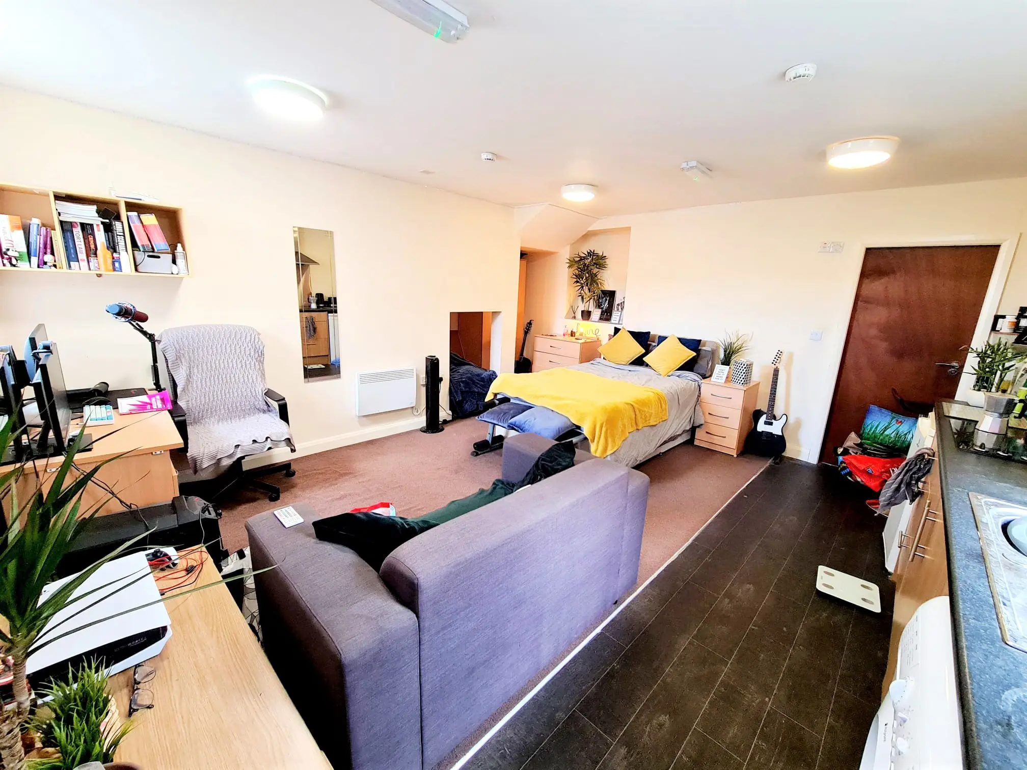 Luxury student studio apartment at Bayt Student Accommodation in Lancaster City Centre, featuring a premium double bed, plush sofa, and modern kitchenette