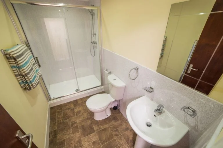 Penny Street student bathroom with shower, toilet, basin and mirror